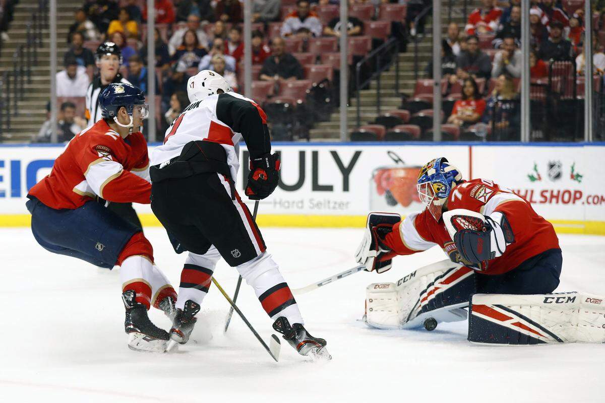 Ottawa Senators left wing Brady Tkachuk (7) attempts a shot at Florida Panthers goaltender Sergei Bobrovsky (72) and defenseman Josh Brown (2) during the first period of an NHL hockey game, Monday, Dec. 16, 2019 in Sunrise, Fla.