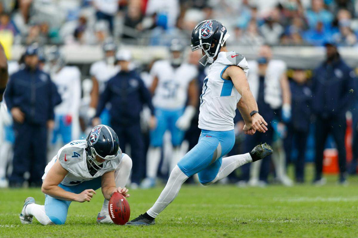 Dec 29, 2024; Jacksonville, Florida, USA; Tennessee Titans punter Ryan Stonehouse (4) holds the ball for kicker Matthew Wright (7) for a field goal attempt against the Jacksonville Jaguars during the fourth quarter at EverBank Stadium. Mandatory Credit: Morgan Tencza-Imagn Images