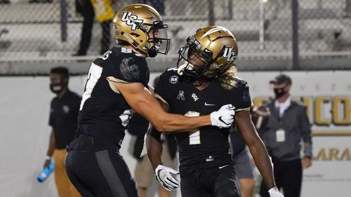 Central Florida wide receiver Jaylon Robinson, right, celebrates his 10-yard touchdown on a pass play against Cincinnati with teammate wide receiver Jacob Harris during the second half of an NCAA college football game, Saturday, Nov. 21, 2020, in Orlando, Fla. (AP Photo/John Raoux)