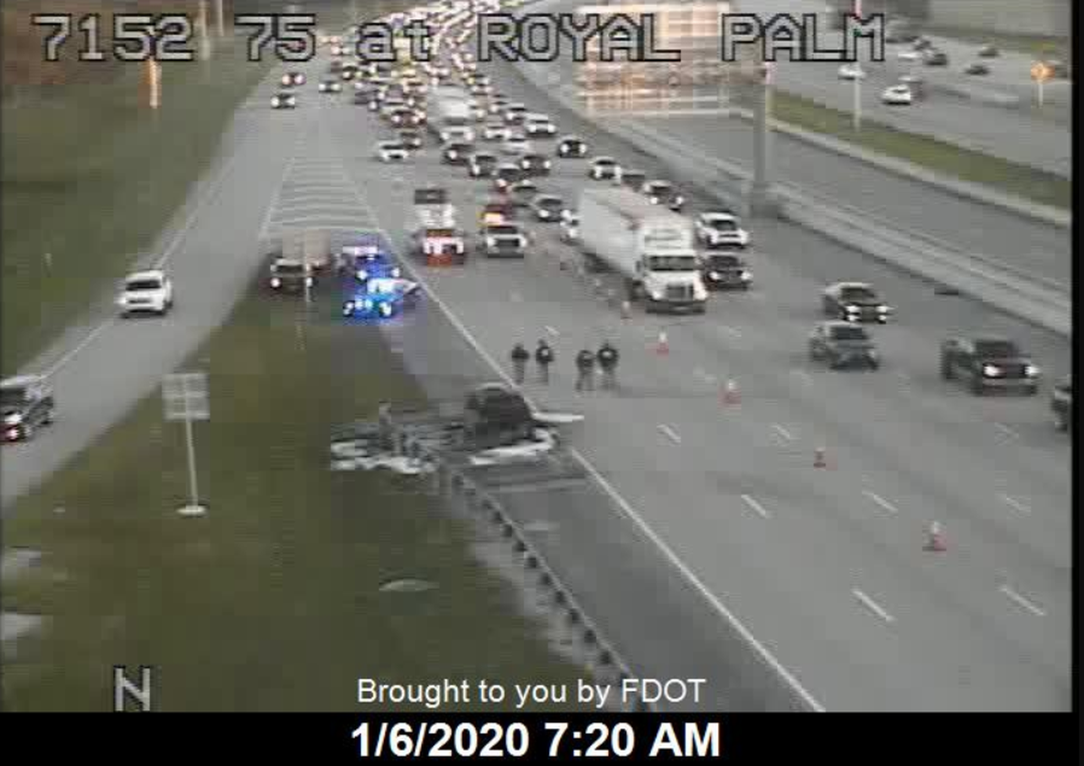 Traffic cameras recorded troopers surrounding a charred car on Interstate 75 by Royal Palm Boulevard early Monday.