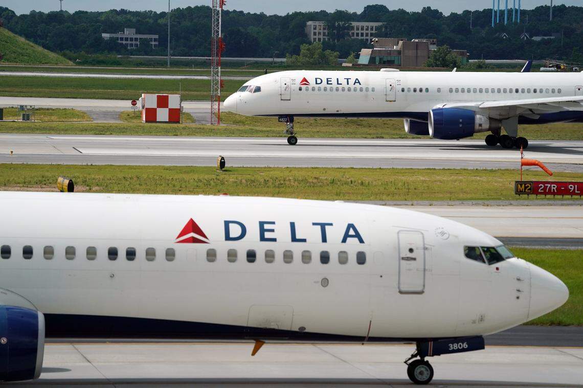Jun 30, 2022; Atlanta, GA, USA; A Delta 737-900ER Atlanta to Miami flight taxis to the runway as another 757 prepares for takeoff during normal operations as off duty Delta Air Lines pilots picketed at Hartsfield-Jackson International Airport as they call out the carrier for mass flight cancellations and push for a new labor contract. The picketing comes before the busy July Fourth travel period gets underway and as Delta has grappled with flight cancellations amid a staffing shortage and surge in travel demand. The airline says the planned union activity will have no impact travel. Mandatory Credit: John David Mercer-USA TODAY NETWORK