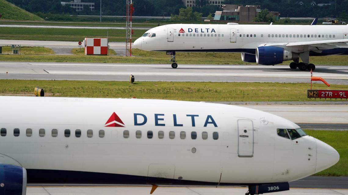 Jun 30, 2022; Atlanta, GA, USA; A Delta 737-900ER Atlanta to Miami flight taxis to the runway as another 757 prepares for takeoff during normal operations as off duty Delta Air Lines pilots picketed at Hartsfield-Jackson International Airport as they call out the carrier for mass flight cancellations and push for a new labor contract. The picketing comes before the busy July Fourth travel period gets underway and as Delta has grappled with flight cancellations amid a staffing shortage and surge in travel demand. The airline says the planned union activity will have no impact travel. Mandatory Credit: John David Mercer-USA TODAY NETWORK