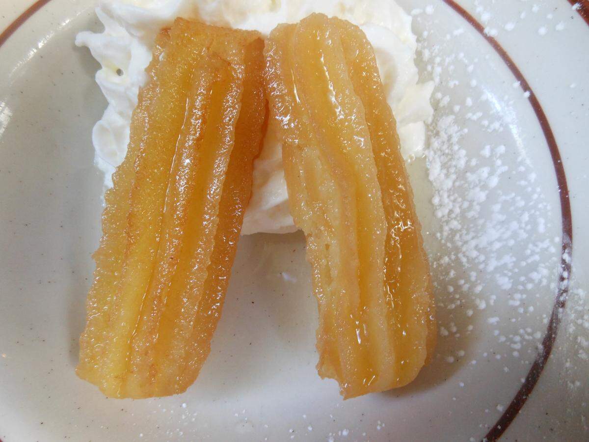 Ustipci, a doughnut that resembles a short fat churro served with kajmak (buttery clotted cream) at Rakija Lounge.