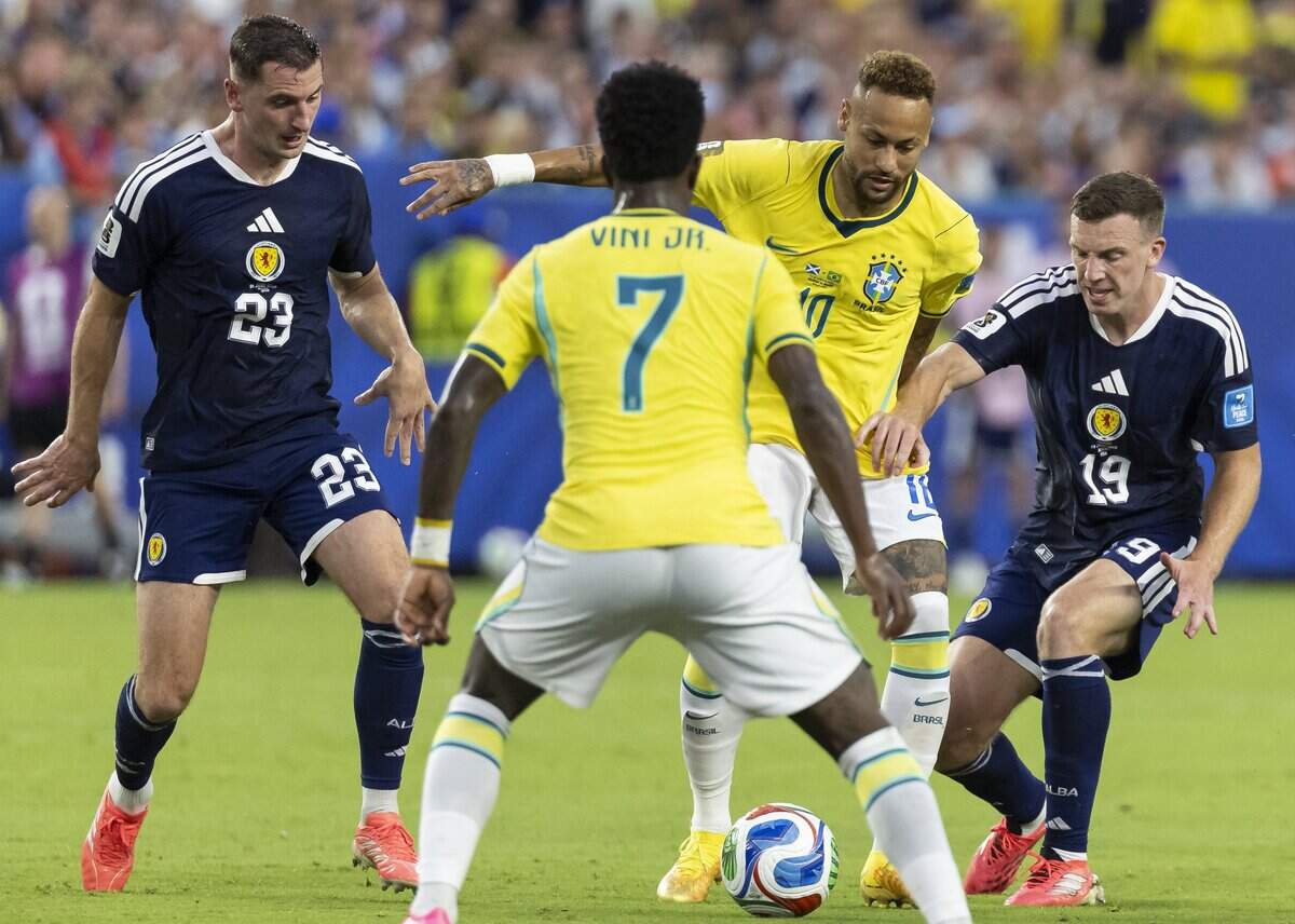 Brazil forward Neymar (10) looks to pass the ball to forward Vinícius Júnior (7) as Scotland midfielder Kenny McLean (23) and midfielder Lewis Ferguson (19) defend in the second half of their World Cup Group C soccer match at Hard Rock Stadium (Miami Stadium) on Wednesday, June 24, 2026, in Miami Gardens, Fla.
