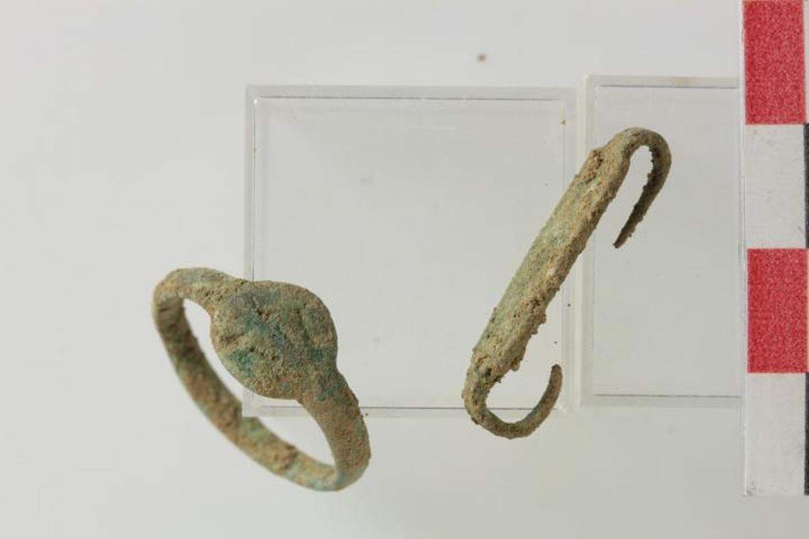 A rare bronze ring and decorated clasp dated part of the site to the early medieval period, archaeologists said.