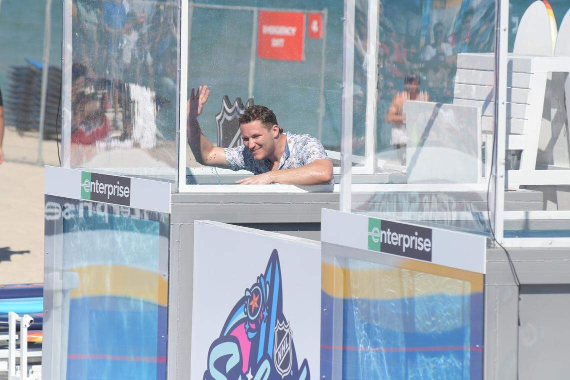 Florida Panthers forward Matthew Tkachuk waves to the crowd after being dunked as part of the Splash Shot challenge on Thursday, Feb. 2, 2023, at the NHL All-Star Beach Festival at Fort Lauderdale Beach.