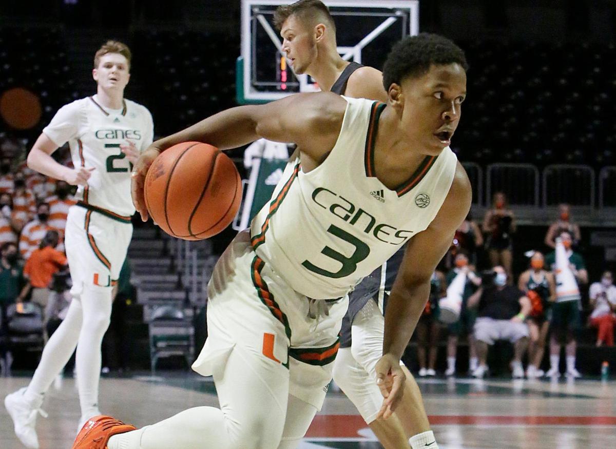 UM Hurricane Charlie Moore (3) dribbles up court against Nova Southeastern Sharks during basketball game on Wednesday, October 20, 2021 at Watsco Center in Coral Gables