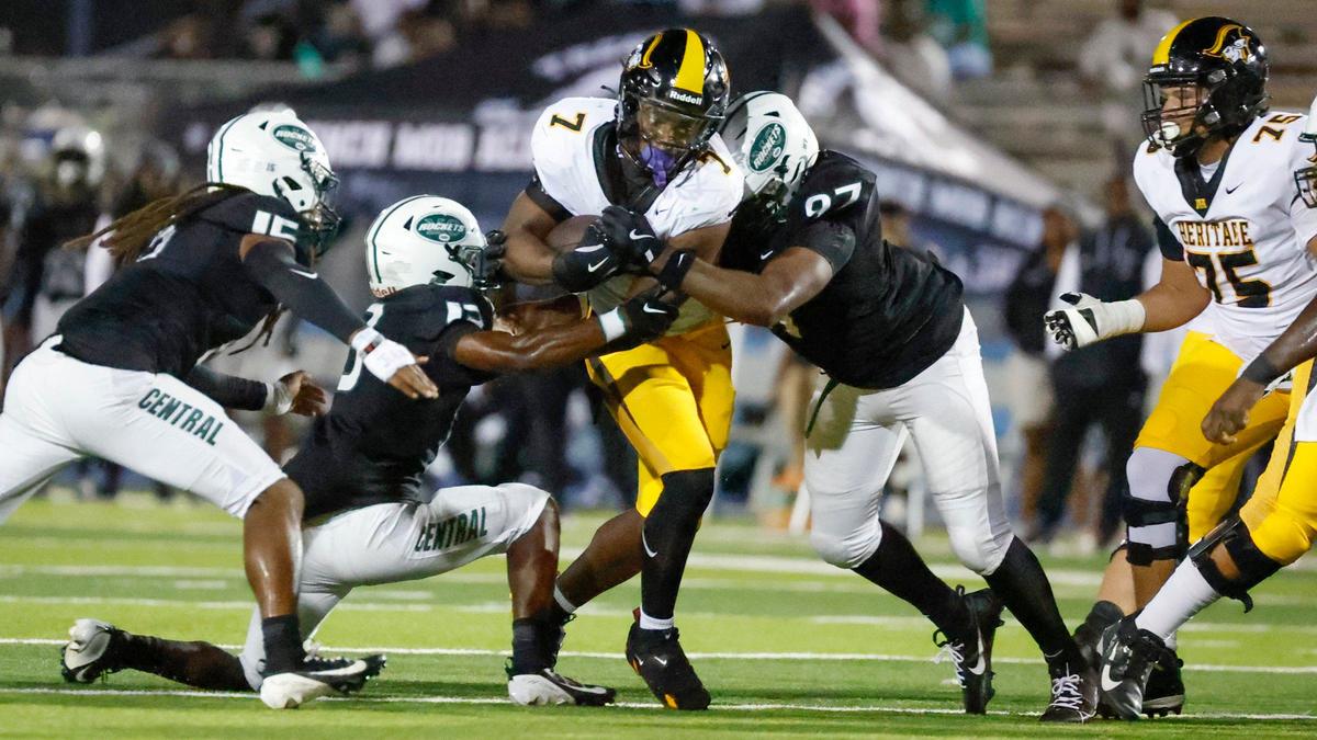American Heritage High running back Louis Byron (7) carries the ball as Central High players defend in the first half at Traz Powell Stadium in Miami Friday, September 20, 2024.