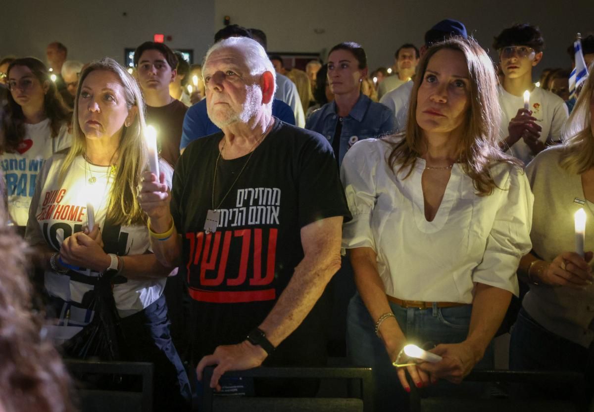 Last year, people held candles up during a ceremony marking one year of the Oct. 7, 2023, attack by Hamas in Israel at the David Posnack Jewish Community Center in Davie.