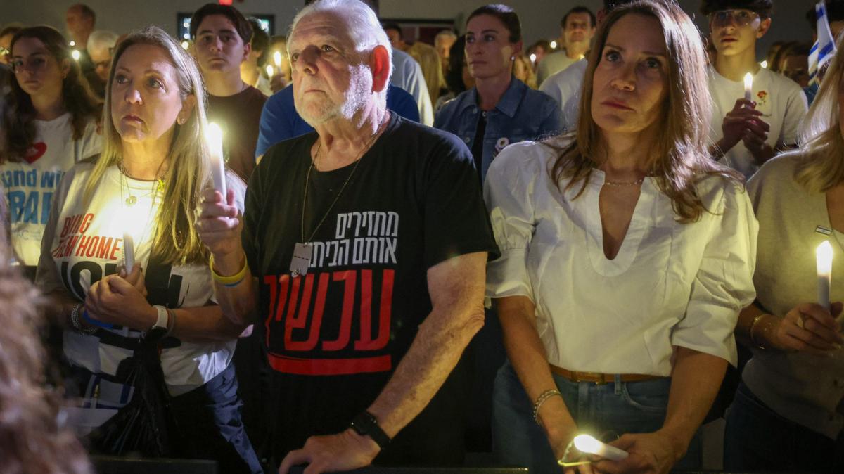 Last year, people held candles up during a ceremony marking one year of the Oct. 7, 2023, attack by Hamas in Israel at the David Posnack Jewish Community Center in Davie.