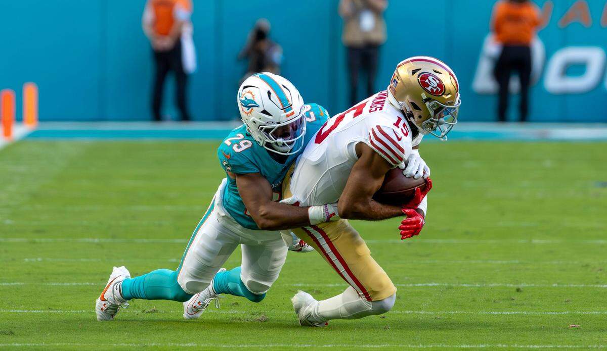 Miami Dolphins cornerback Kendall Fuller (29) brings down San Francisco 49ers wide receiver Jauan Jennings (15) during the first half of their NFL game at Hard Rock Stadium on Sunday, Dec. 22, 2024, in Miami Gardens, Florida.