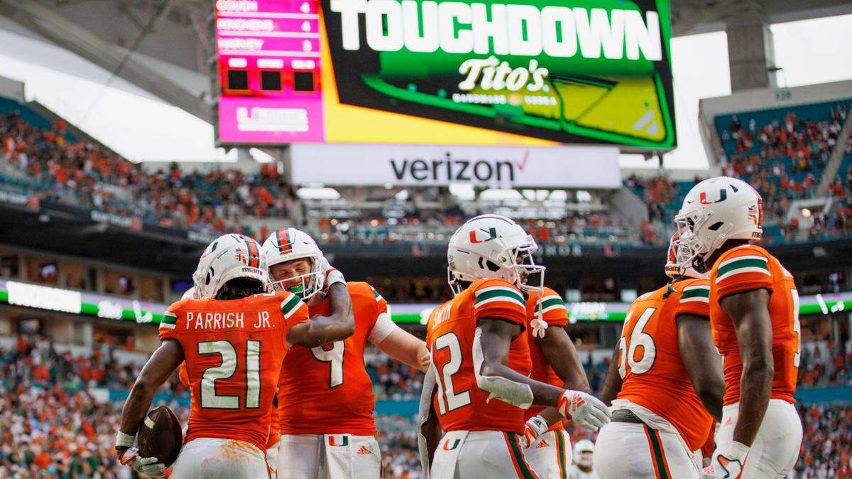 Miami Hurricanes running back Henry Parrish Jr. (21) celebrates with teammate quarterback Tyler Van Dyke (9) after scoring a touchdown during the second quarter of an ACC conference football game against North Carolina Tar Heels at Hard Rock Stadium on Saturday, October 8, 2022 in Miami Gardens, Florida..