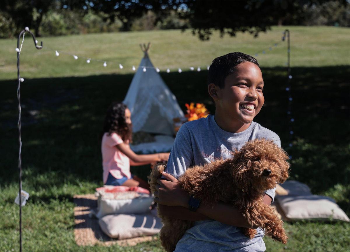 Aiden Ramsankar plays with the family dog as his sister Ava prepares for a picnic. They created their Sweet Sentiments business to raise funds for UM’s Diabetes Research Institute Foundation after Aiden was diagnosed with Type 1 diabetes.
