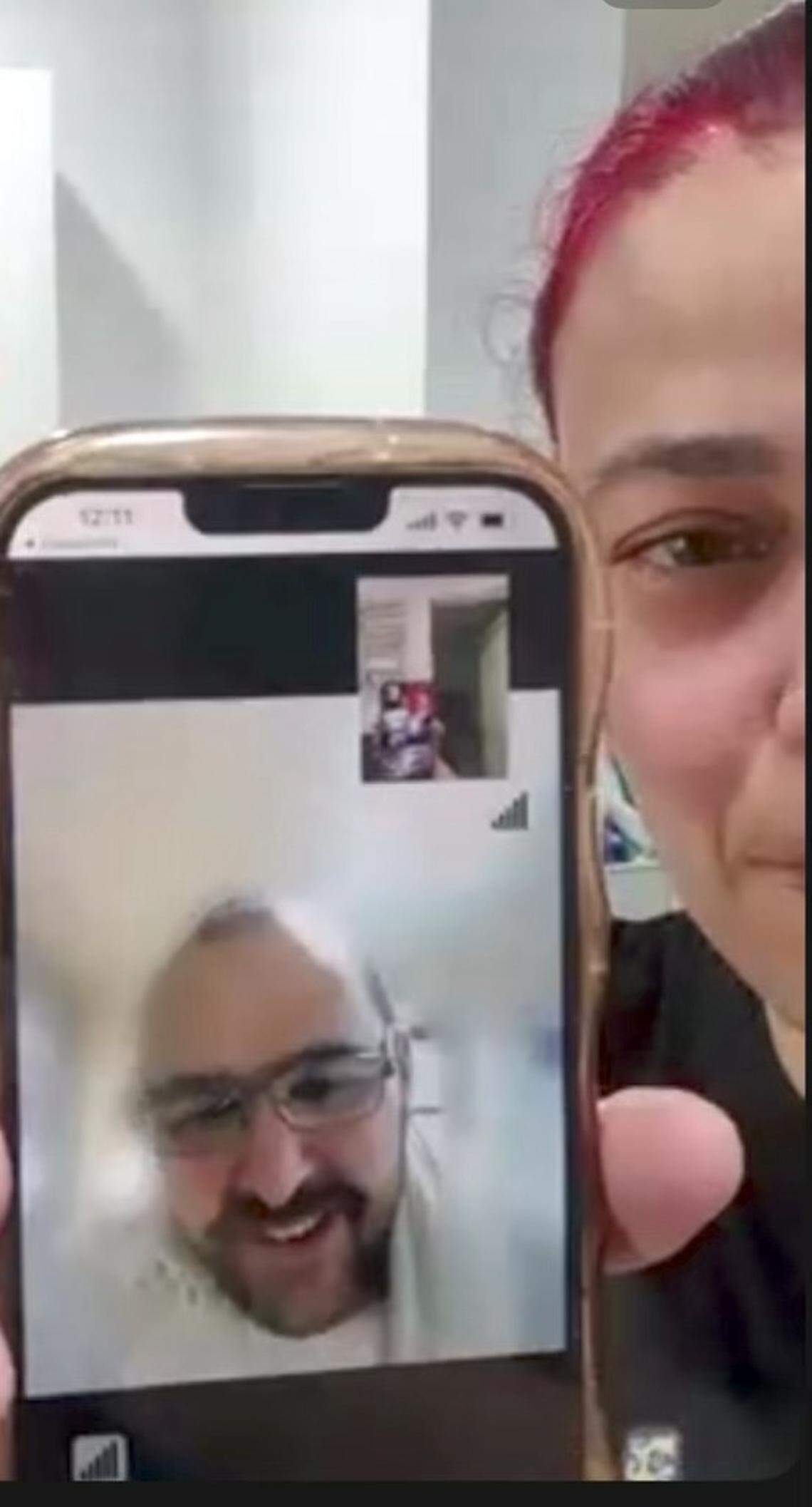 Daimarys Hernandez holds a cell phone showing a video call with her partner Pedro Lorenzo Concepcion, who was held in Alligator Alcatraz for several weeks before being transferred to Krome detention center in Miami.