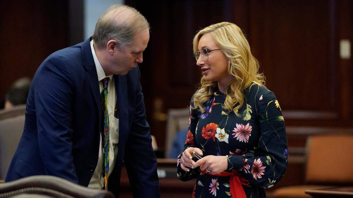 Florida Senate President Wilton Simpson, left, talks with Minority Leader Sen. Lauren Book of Plantation during a legislative session at the Florida State Capitol, Thursday, March 10, 2022, in Tallahassee, Fla.