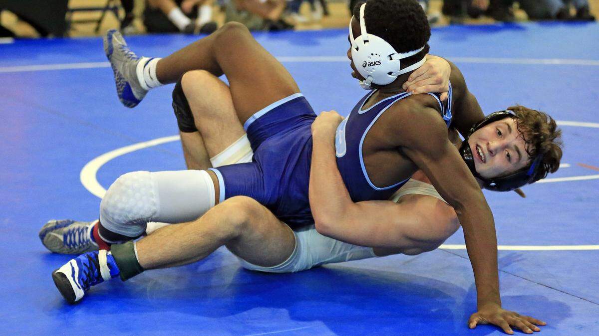 Brevin Balmeceda, at bottom, battles Cardeionte Wilson of Miami Palmetto high School. Balmeceda goes on to defeat Wilson during GMAC wrestling finals at Ronald W. Reagan Doral Senior High School on Sat., Feb. 3, 2018.