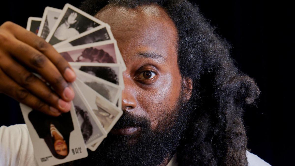 Emmanuel George holds a deck of Black Broward Flashcards that he created to celebrate and educate about the county’s rich Black history.