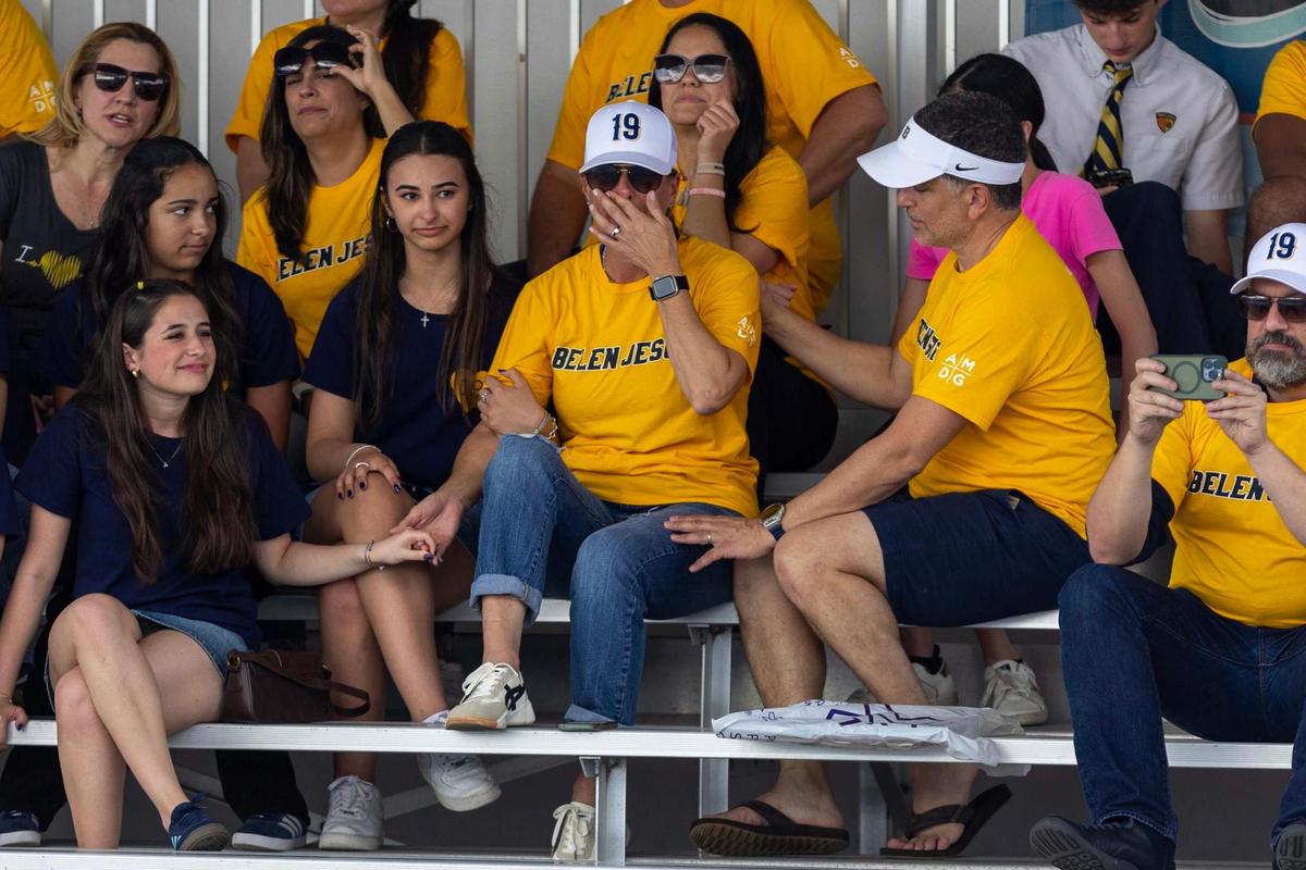 Miami, Florida, April 8, 2025 - Lucas Osuna’s mother Jeanette Garcia-Osuna, center, is comforted by her husband Joe Tamer, right as she holds Annie Simon’s hand during a match against Coral Gables High.