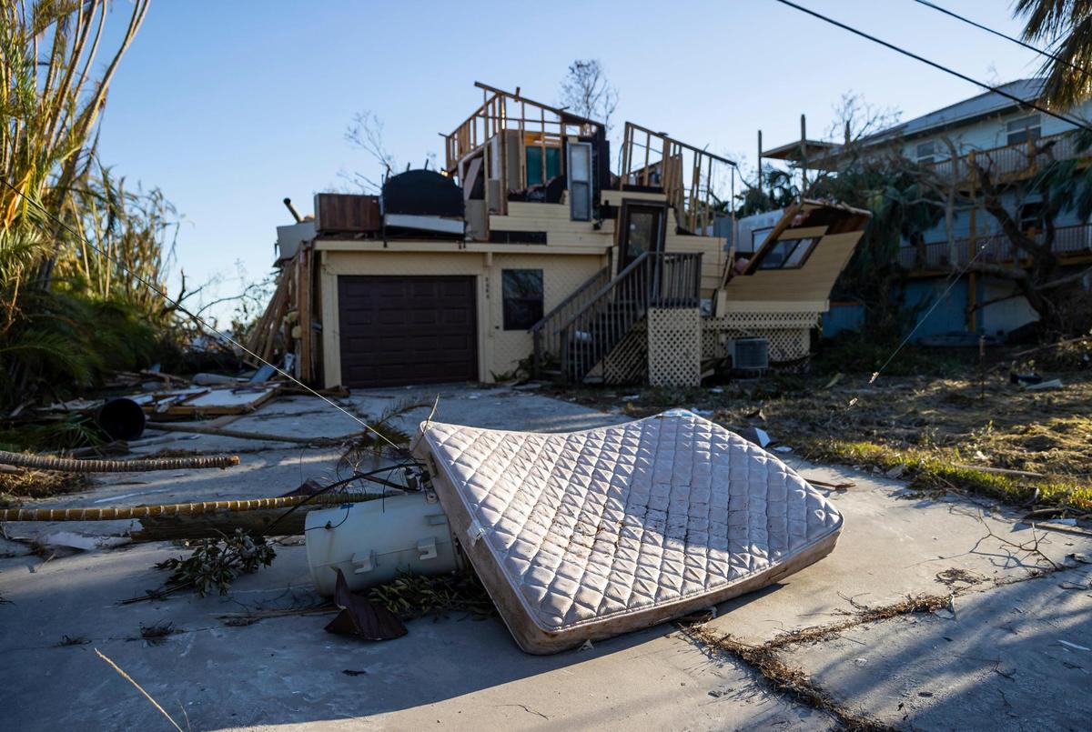A mattress lies on top of an electrical transformer due to hurricane damage near a home on the southern tip of St. James City on Friday, Sept. 30, 2022, in Pine Island, Florida. Hurricane Ian made landfall on the coast of Southwest Florida as a Category 4 storm Wednesday afternoon, leaving areas affected with flooded streets, downed trees and scattered debris.