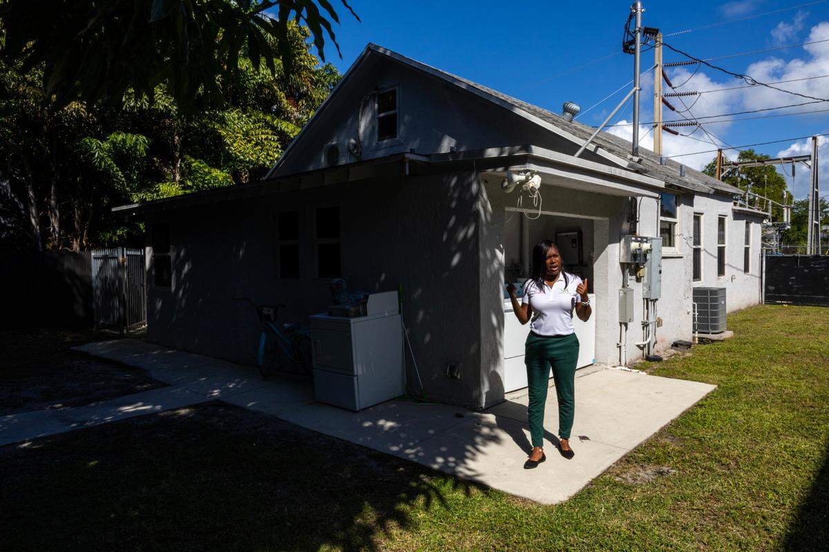 Founder Shavon Saint Preux shows reporters the yard and laundry area for residents at Saint House on Monday, October 21, 2024, in Miami, Fla. Saints House is a transitional housing program for those aging out of foster care.