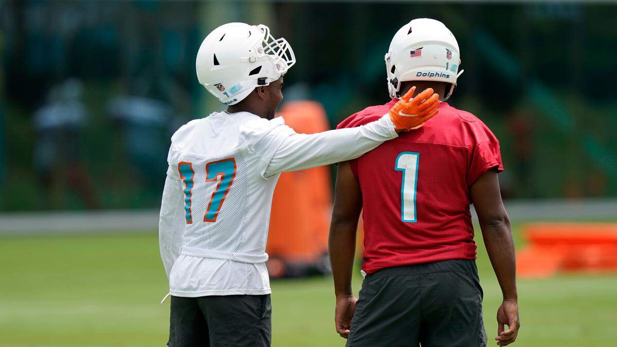 Miami Dolphins wide receiver Jaylen Waddle (17) and quarterback Tua Tagovailoa (1) take part in drills at the NFL football team’s practice facility, Tuesday, June 7, 2022, in Miami Gardens, Fla. (AP Photo/Lynne Sladky)