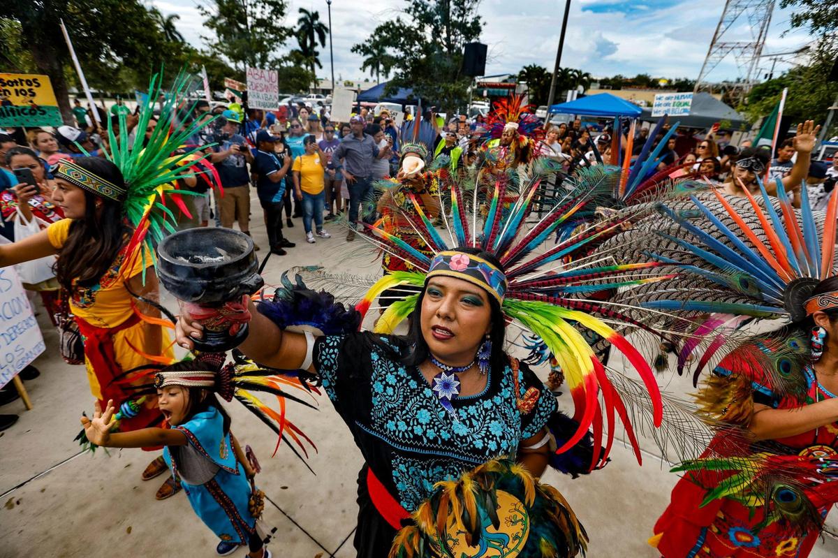 Lizbeth Viera joins Aztec dancers with the Ameyal Mexican Cultural Organization as they perform a prayer in motion for all immigrants fighting for their rights to co-exist during a “Freedom For All” rally in Homestead, Florida on Saturday, July 1, 2023. The large crowd gathered in front of Homestead City Hall to protest the bills passed by the Florida Legislature and signed into law by Gov. Ron DeSantis.