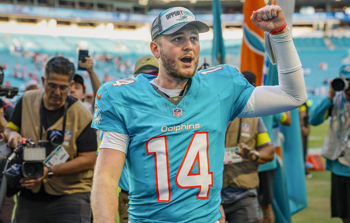 Miami Dolphins quarterback Quinn Ewers (14) pumps his fist as he walks off the field after the Dolphins defeat the Tampa Bay Buccaneers during their NFL football game at Hard Rock Stadium in Miami Gardens, Florida, on Sunday, December 28, 2025.