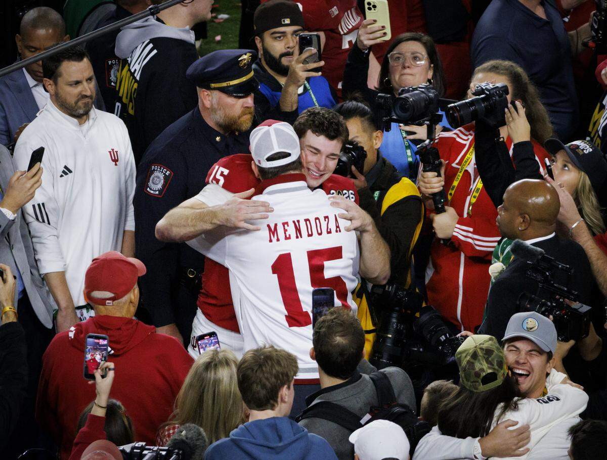 Indiana Hoosiers quarterback Fernando Mendoza (15) hugs his father Fernando Mendoza Sr. after winning the College Football Playoff National Championship Game against the Miami Hurricanes at Hard Rock Stadium on Monday, Jan. 19, 2026 in Miami Gardens, Fla.