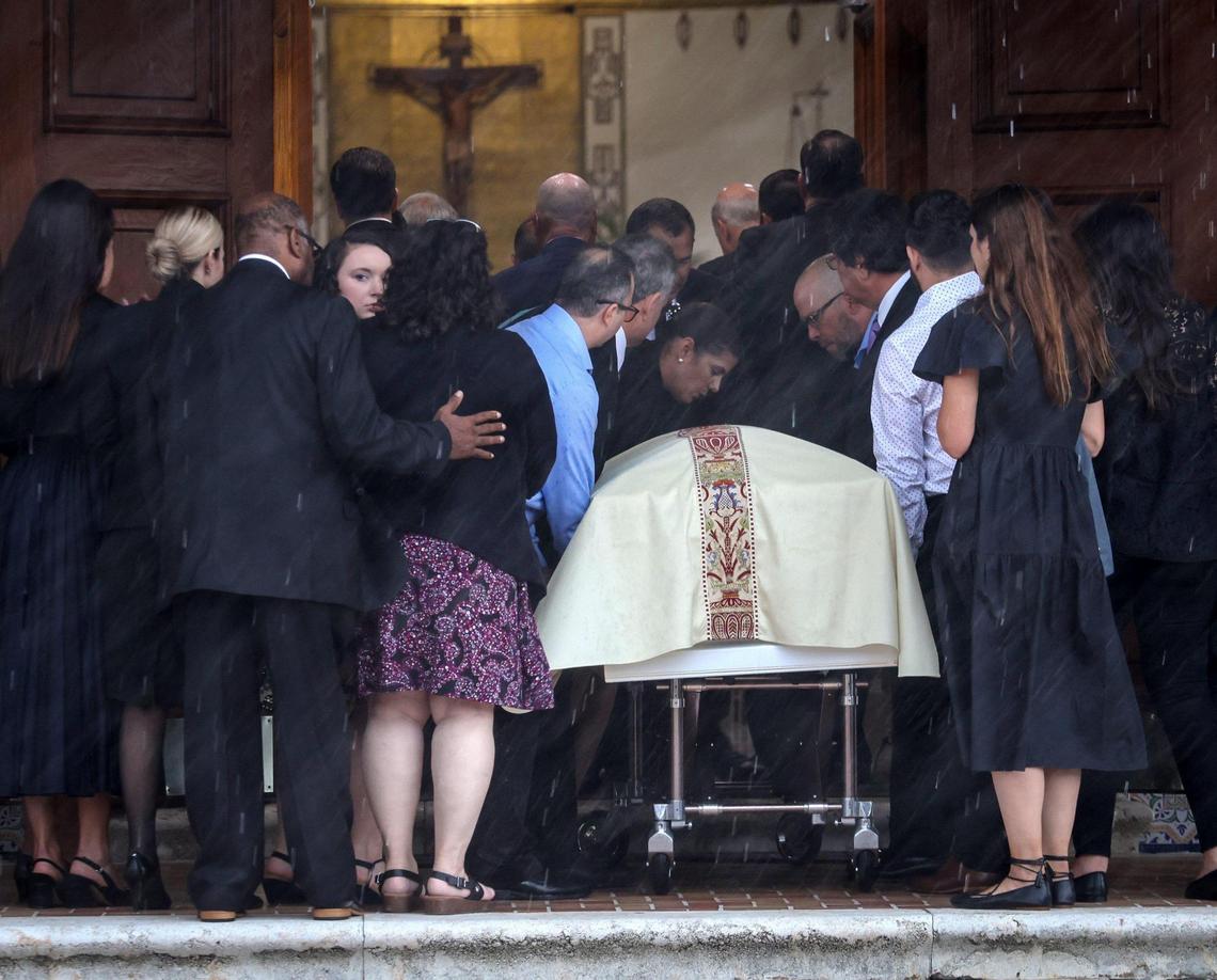 Family members, loved ones and friends stand next to the casket of Anaely Rodriguez as it is brought into St. Joseph Catholic Church in Miami Beach. The funeral Mass was held for the four members of the Guara family — Marcus Guara, 52, Anaely, 42, and their two daughters, Lucia Guara, 10, and Emma Guara, 4 — at the church on July 6, 2021.