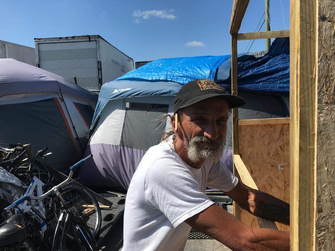 Patrick Wiese, convicted of lewd conduct toward a minor, leans on the plywood trailer he was building at the encampment of sex offenders outside Hialeah. Miami-Dade is promising to dismantle the camp after a judge tosssed a lawsuit trying to block enforcement of the county's anti-camping rule.