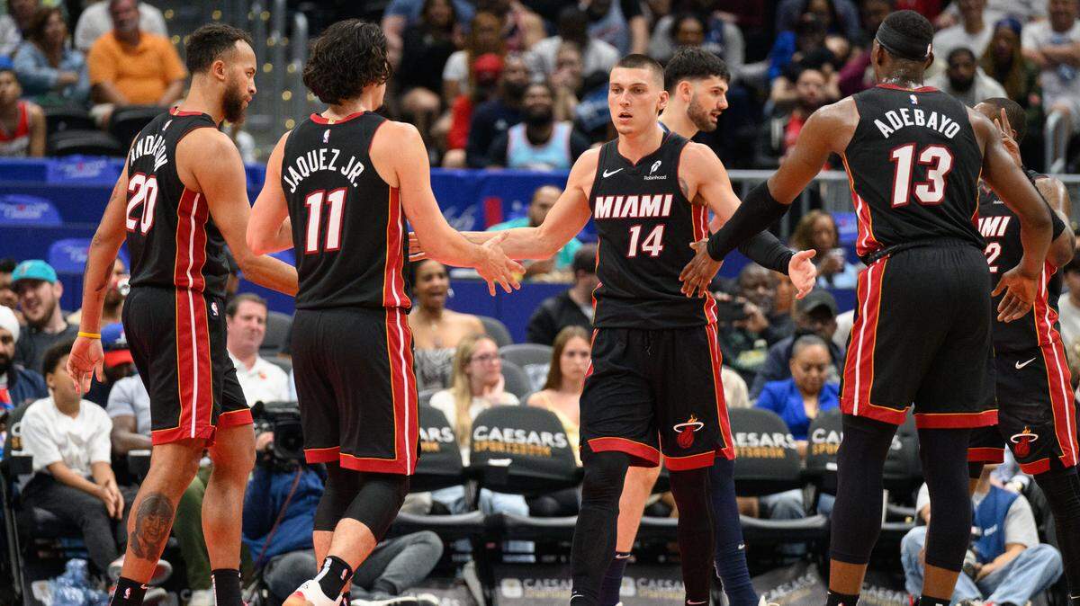 Miami Heat guard Tyler Herro (14) reacts with center Bam Adebayo (13), and guard Jaime Jaquez Jr. (11) during the third quarter against the Washington Wizards at Capital One Arena.