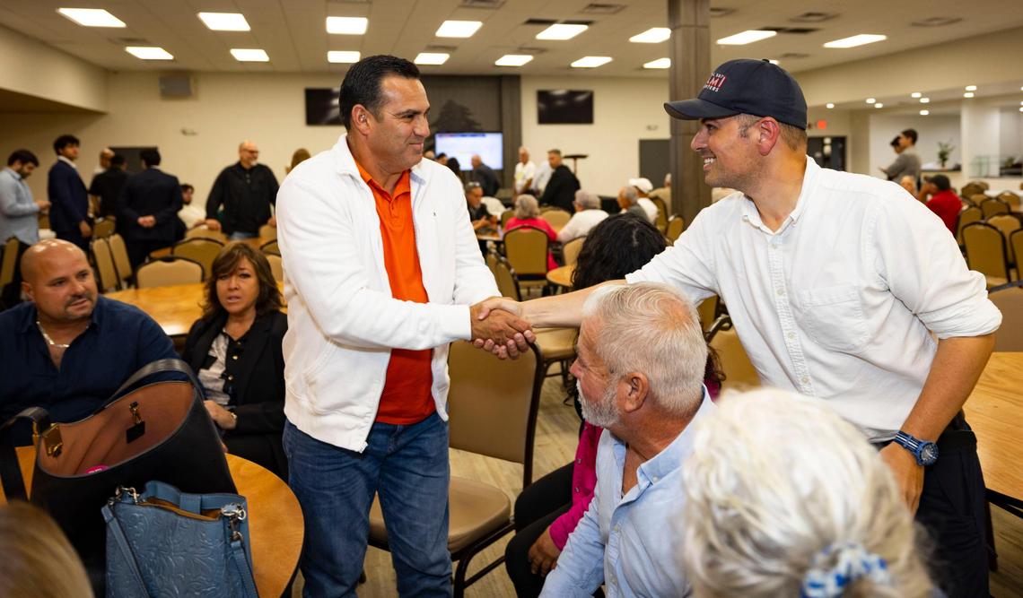 Jose Regalado, right, shakes hands with supporters during his watch party at Our Lady of Lebanon Church on Tuesday, June 3, 2025.
