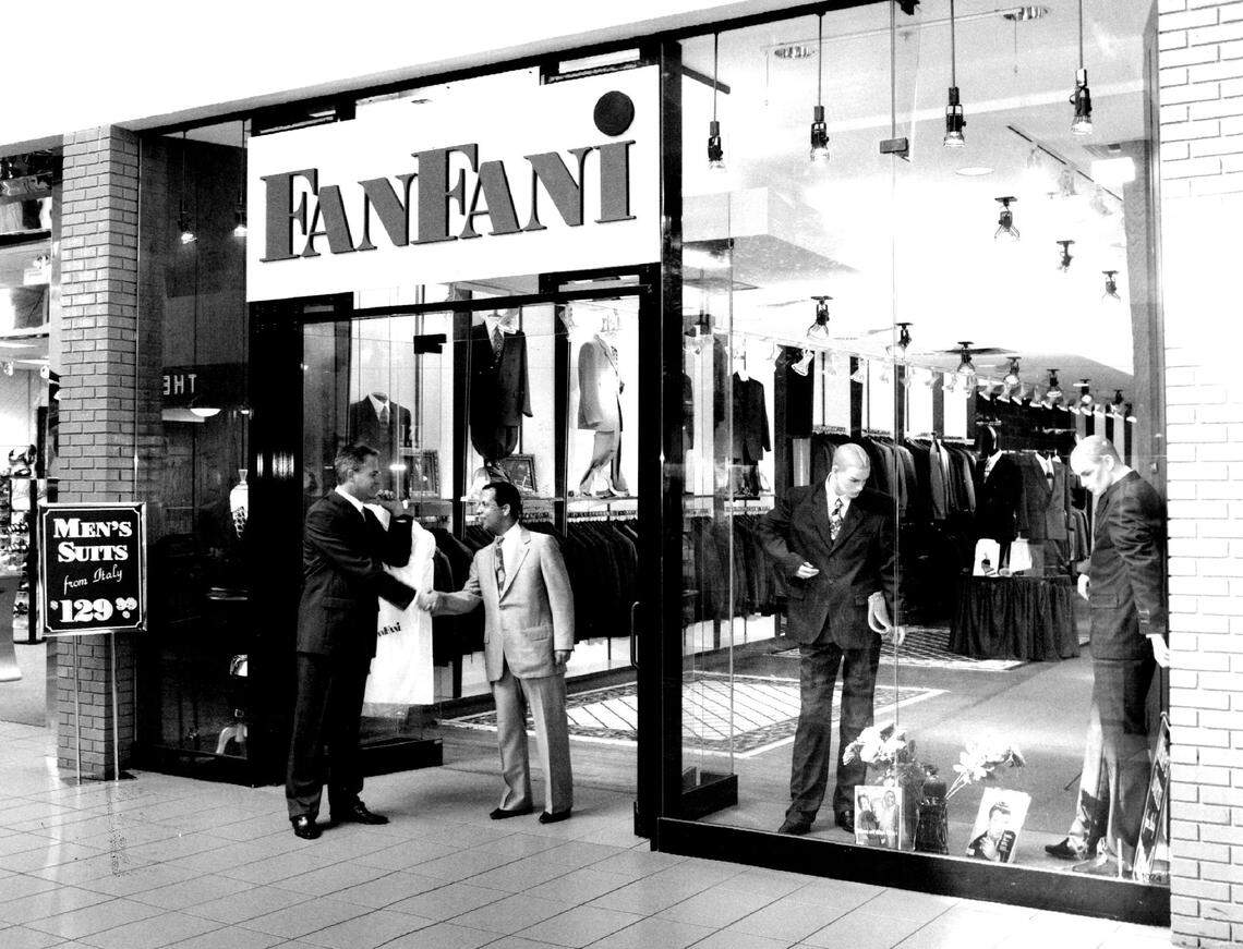 A store owner greets customers at Westland Mall in 1998.