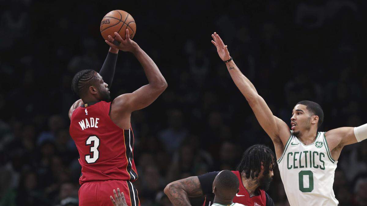 Miami Heat guard Dwyane Wade (3) shoots over Boston Celtics forward Jayson Tatum (0) during Monday’s game. (AP Photo/Charles Krupa)