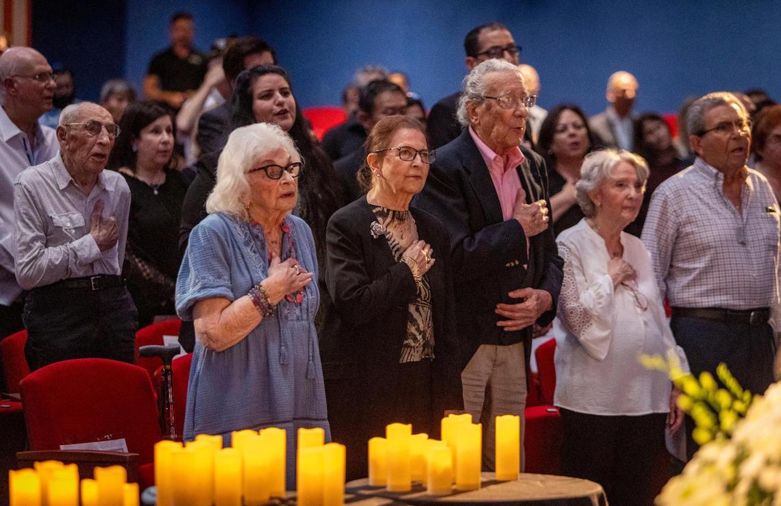 Miami Beach, FL, April 27, 2025 - Holocaust survivors place their hand on their chest as they sing the Star Spangled Banner at the start of a ceremony to Commemorate Yom HaShoah, Holocaust Remembrance Day at Temple Emanu-El in Miami Beach
