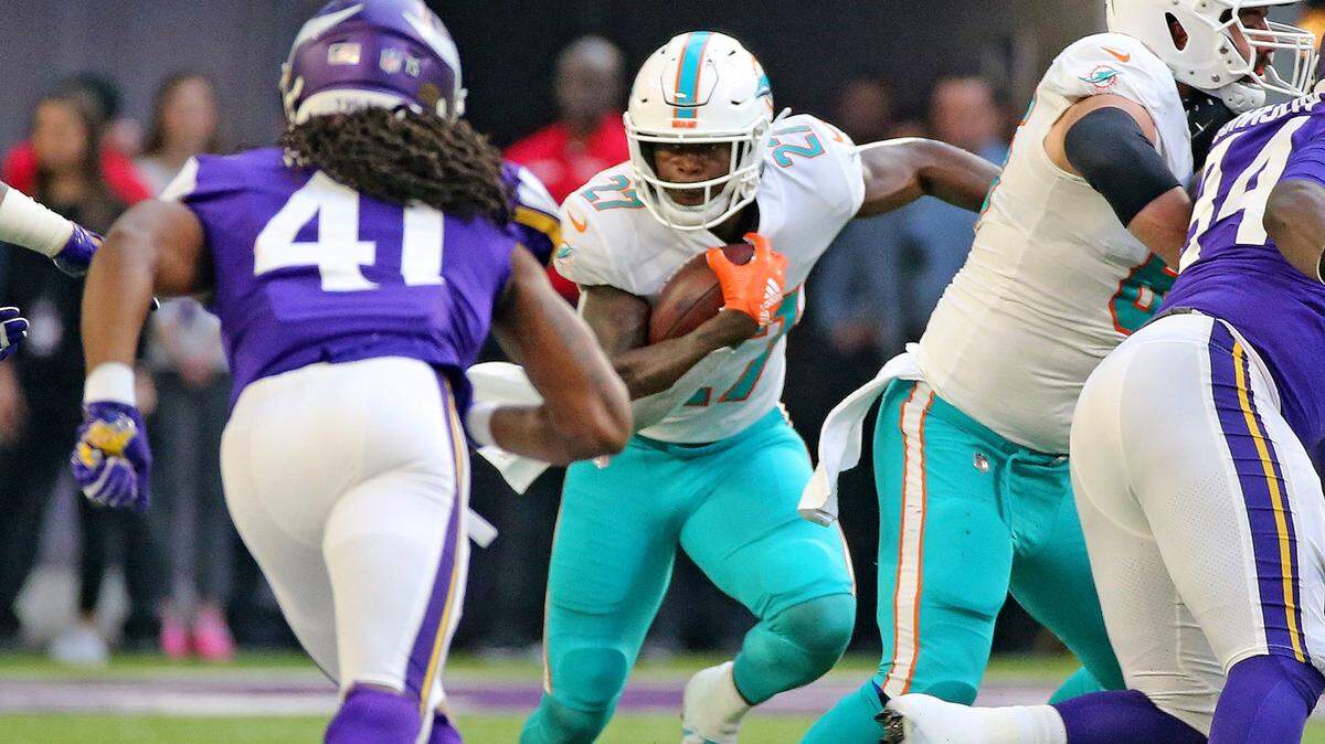 Miami Dolphins running back Kalen Ballage (27) runs the ball on a wildcat play against Minneaota. The Dolphins maintain slim playoff hopes entering Sunday’s game against Jacksonville.