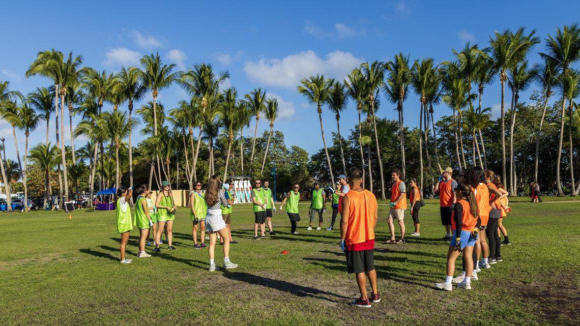 File art: Attendees participating in the Miami's Trashiest Singles event, get instructions from organizer Caiti Waks, (center), the co-founder & President of the Debris Free Oceans, at Peacock Park, on Saturday February 08, 2025.