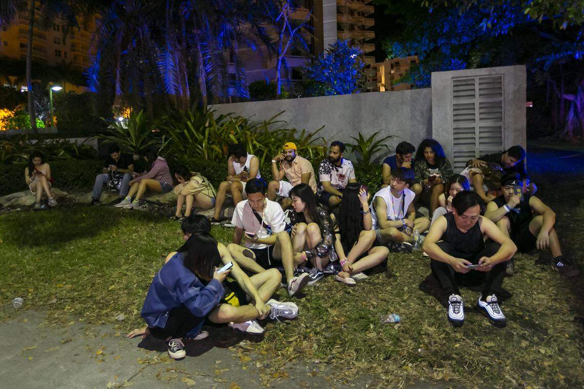 Attendees wait for ride shares in Brickell after walking across the Rickenbacker Causeway when they left the 2019 Ultra Music Festival in Virginia Key, Florida on Saturday, March 30, 2019.