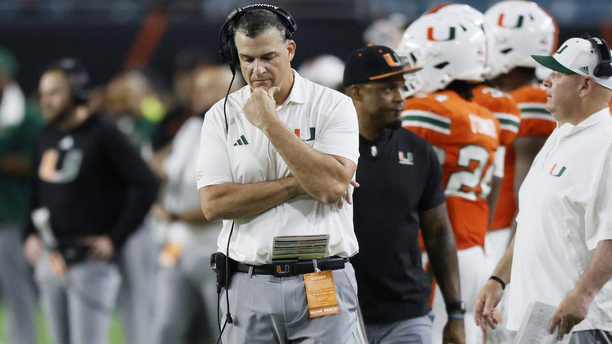 Miami Hurricanes head coach Mario Cristobal walks the sidelines late in thje fourth quarter during the game against the Louisville Cardinals of their NCAA football game at Hard Rock Stadium in Miami Gardens, Florida, on Friday, October 17, 2025.