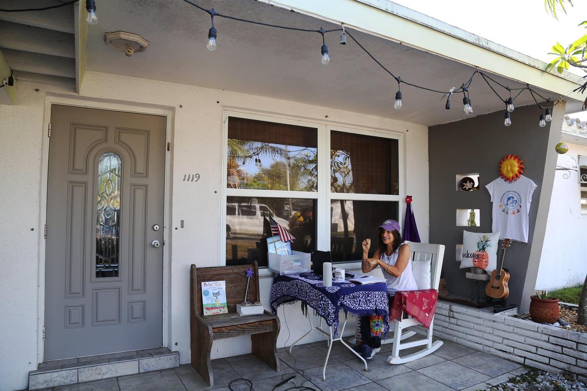 Sheryl Muñoz is a pre-K Broward County Public Schools teacher at Gulfstream Early Learning Center. On Monday morning, March 30, 2020, she sings and does sign language with her class from the front porch of her Hollywood home as all Broward County Schools have transitioned to online learning during the coronavirus outbreak.