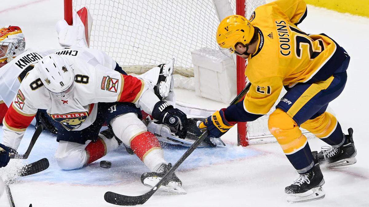Florida Panthers defenseman Ben Chiarot (8) stops a shot by Nashville Predators center Nick Cousins (21) during the third period of an NHL hockey game Saturday, April 9, 2022, in Nashville, Tenn. The Panthers won 4-1. (AP Photo/Mark Zaleski)