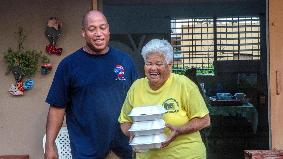 Rescuer Rolando Delgado with Iris Gonzalez, whom he rescued from her house during Hurricane Fiona in Las Ochentas neighborhood in Salinas, Puerto Rico, on Friday, Sept. 23, 2022.