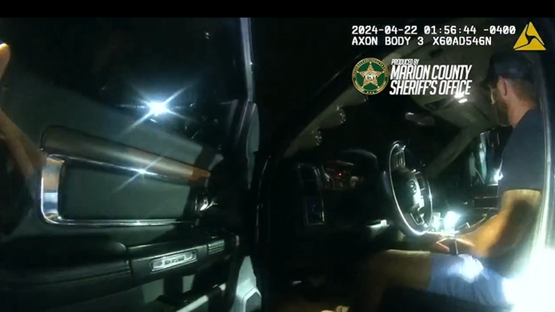 A motorist found unconscious behind the wheel of his vehicle starts singing when deputy knocks on the window, Florida investigators say.