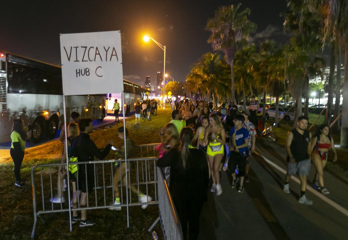 Festival goers make their way toward shuttle buses after attending the second day of the 2019 Ultra Music Festival in Virginia Key, Florida on Sunday, March 31, 2019.