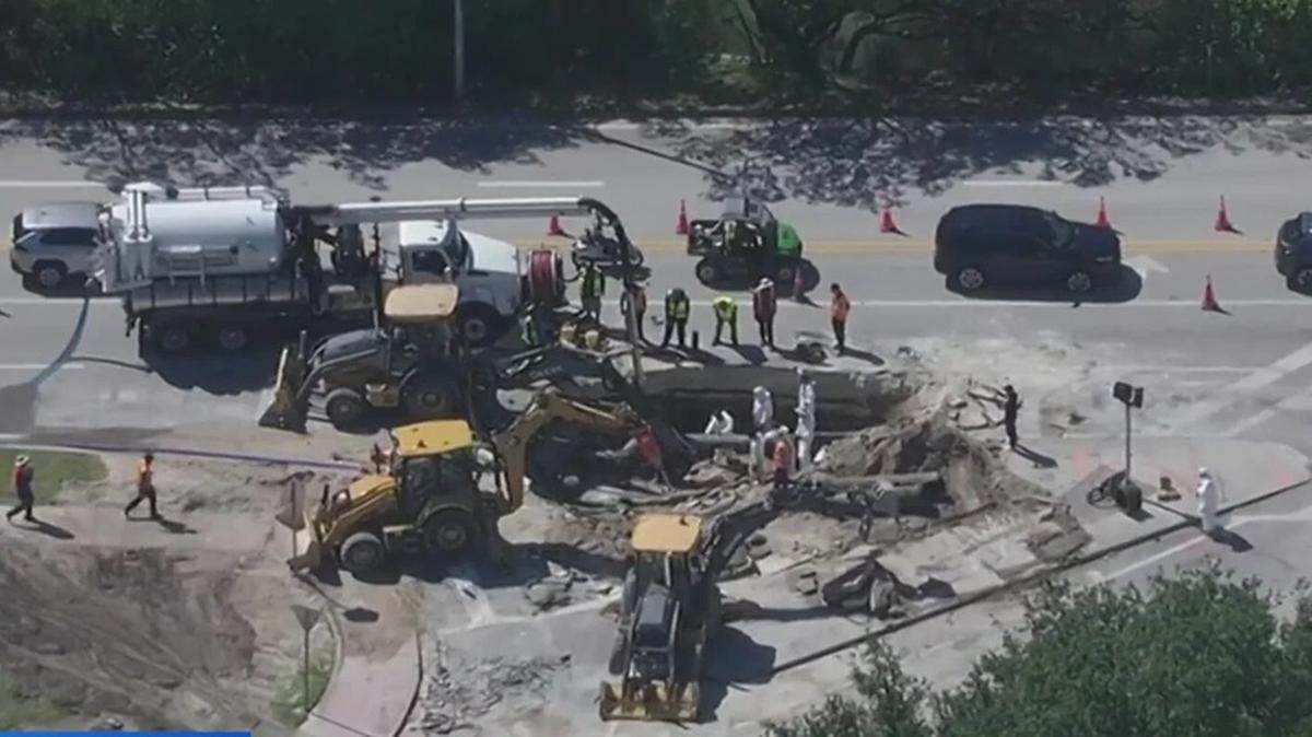 Crews work to fix a water-main break on Friday, May 15, 2026, under Dade Boulevard and Prairie Avenue, near the Miami Beach Convention Center.