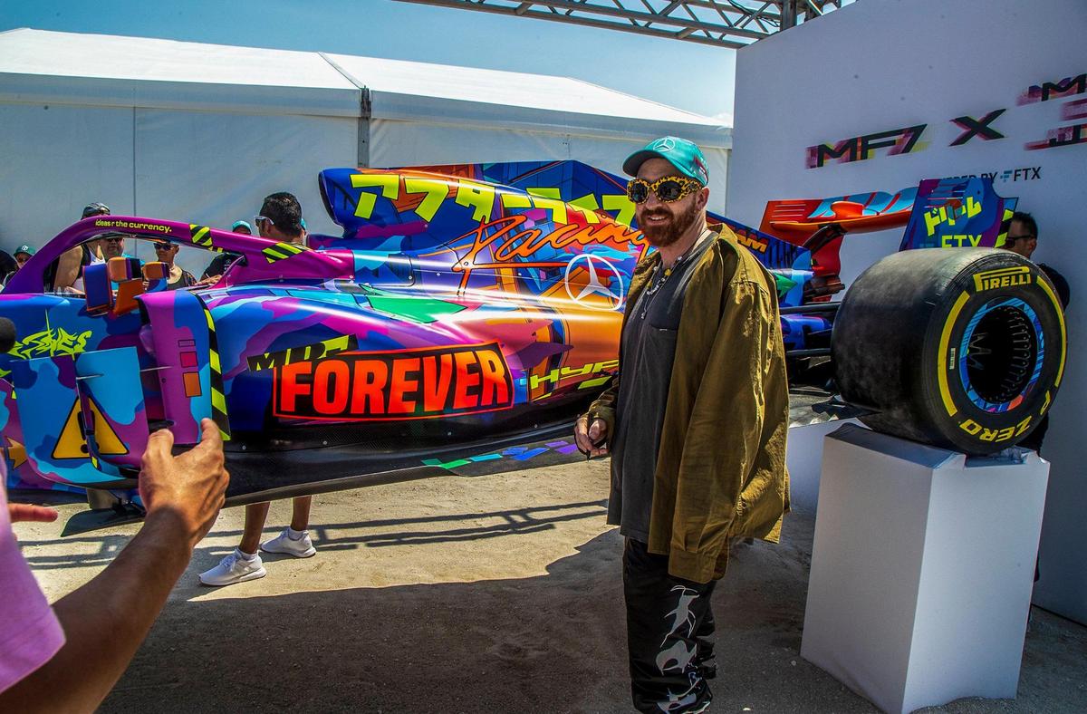 Artist Mad Dog Jones stands next to the replica Mercedes Formula 1 car he painted during the Day One of the FTX Off the Grid Fan Fest on the sands of South Beach to celebrate the F1 race weekend on Friday, May 6, 2022.