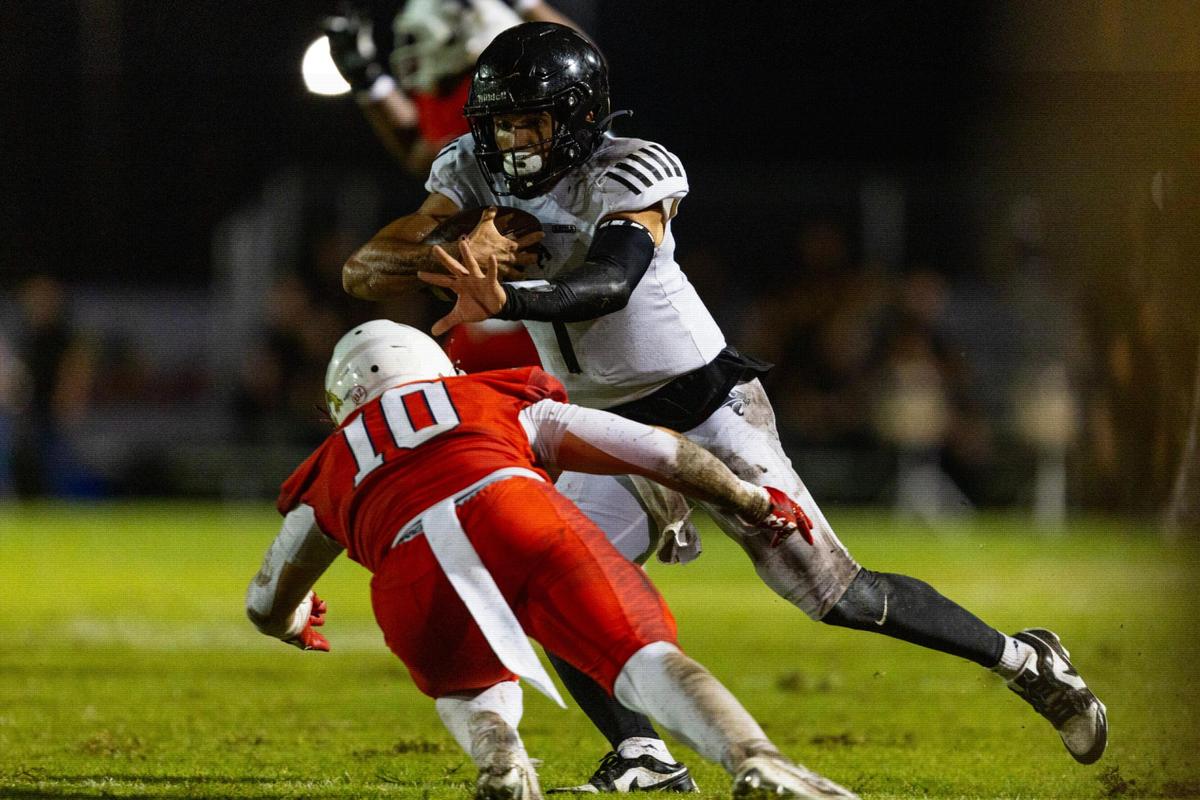 Western quarterback Davi Belfort (1) stiff arms Milton High linebacker Hayden Tumminia (10) as he runs with the ball during the 2023 Broward County National Football Showcase at Western High School in Davie, Florida, on Thursday, August 24, 2023.