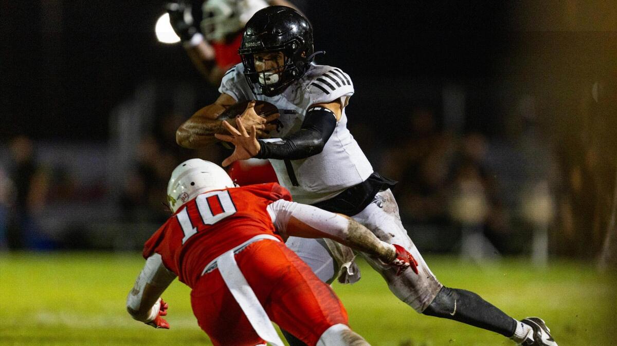 Western quarterback Davi Belfort (1) stiff arms Milton High linebacker Hayden Tumminia (10) as he runs with the ball during the 2023 Broward County National Football Showcase at Western High School in Davie, Florida, on Thursday, August 24, 2023.
