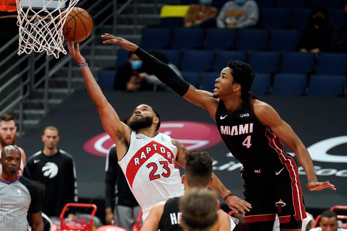 Toronto Raptors guard Fred VanVleet (23) gets fouled by Miami Heat forward KZ Okpala (4) during the first half of an NBA preseason basketball game Friday, Dec. 18, 2020, in Tampa.