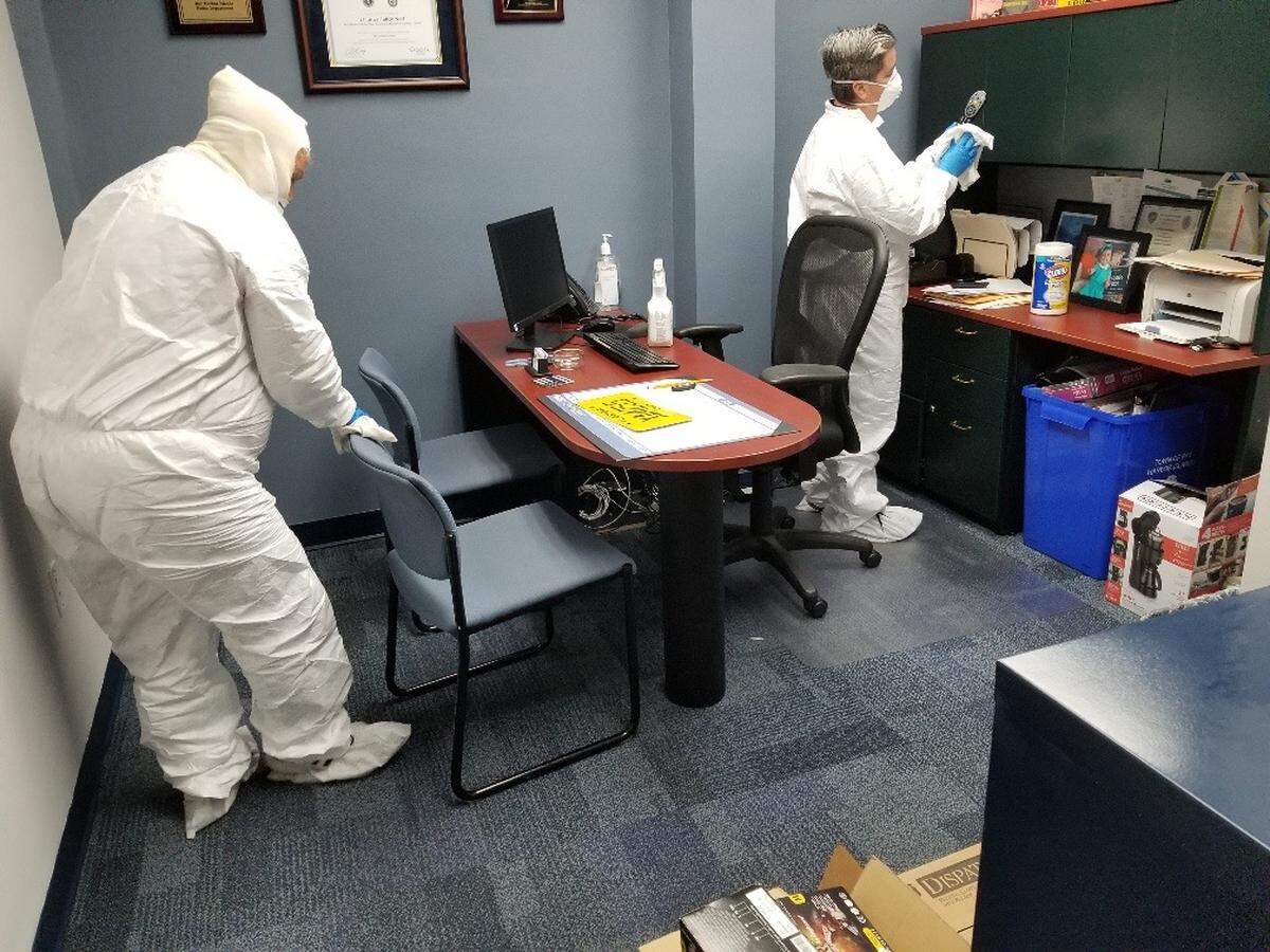 Workers disinfect Bay Harbor Islands Town Hall on Saturday, March 14, 2020. A town employee has tested positive for COVID-19.